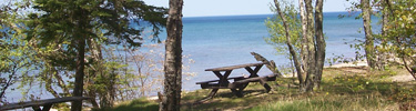 Picnic table waits patiently for visitors near the mouth of the Hurricane River on Lake Superior within Pictured Rocks National Lakeshore.