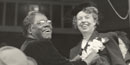 Mary McLeod Bethune pins a corsage on Eleanor Roosevelt.