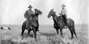 Two cowboys on their horses.