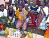 Photo: In a new version of a long-standing cultural practice, a woman symbolically cleanses herself in the wake of her husband’s death by eating a meal of traditional foods (Click here to read full story).