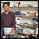 Man standing in front of shelves of office supplies