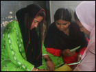 Women practice a writing exercise.