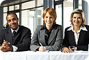 Two women and a man ready to interview a job seeker.