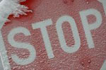 A snow covered stop sign. 