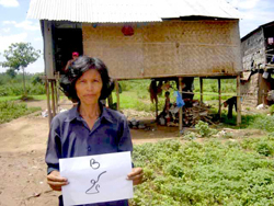 A client displays her designated plot number during land measurements on the river island of Koh Pich, near Phnom Penh.