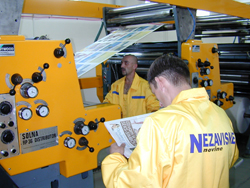 An employee reads a copy of the Bosnian newspaper Nezavisne Novine hot off the press.