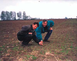 Photo: arm owner Vladimir Shapel and Farmer to Farmer volunteer Peter Pitts inspect alfalfa at the Voystom Farms in Belarus.