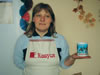 Strumochok Director Ilona Gudkova models a full-body apron and coffee mug displaying a St. Valentine's greeting both of which are produced and made-to-order at Social Company.