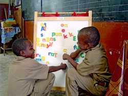 Second-grade students Tyrone Josephs, 7, and Jeamel Byfield, 9, form words out of block letters at the Salt Marsh Primary School near Montego Bay, Jamaica.