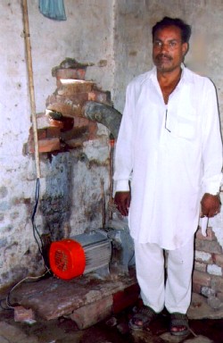 Farmer Raasoo Rahis uses an electric-powered pump to water his fields.
