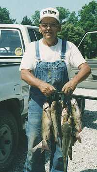 Photo of an angler displaying a stringer of fish - Photo credit:  U.S. Fish and Wildlife Service