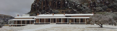 Photo of snow-covered Post Hospital at Fort Davis National Historic Site.