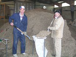 Photo of two men putting grass seed into bags - Photo credit:  U.S. Fish and Wildlife Service / Les Peterson