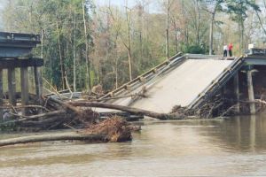 photo of a failed bridge with debris around it