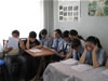 Before stepping into their roles as prosecutors, lawyers and witnesses in a mock trial exercise, schoolchildren review and discuss materials related to the hypothetical case