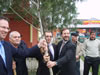 USAID's Mark Hannafin (far left) and Jim Carlson (far right) participate in a tree planting in Dagestan to commemorate a new partnership among the International Rescue Committee, a dairy cooperative, and a dairy processing plant that will open new markets for the products of local farmers.