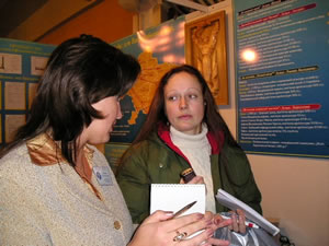 Educational posters to raise awareness of human trafficking provide the backdrop for a conversation between a member of NGO Volyn Perspectives and a migrant at a Ukraine border crossing checkpoint.