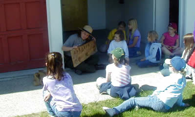 A ranger teaching school children how to read cattle brands.