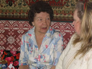 Milaniya Achkasova thanks a volunteer for much-needed food she received during the holidays last year