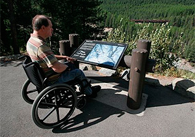 visitor in wheelchair at a wayside exhibit