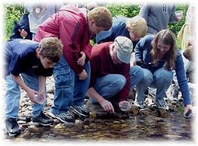 Photo of children collecting water samples - Photo credit:  U.S. Fish and Wildlife Service