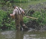 Photo of a man evaluating a body of water