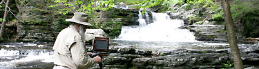 Noted photographer Clyde Butcher at Factory Falls PA; the park Friends exhibited his photos of the park. Photo by Nikki Butcher.