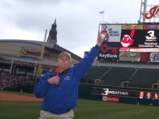 Benson holds a baseball in the air.