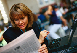 Woman using portable computer with wifi connection in a public setting.