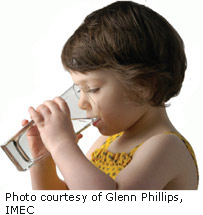 Picture of a girl drinking water at home. 