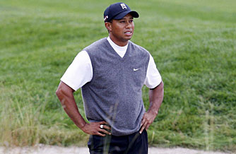 Tiger Woods stands in a fairway bunker on the 10th hole during his up-and-down first round on Friday.