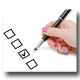 hand with pen marking a checkbox