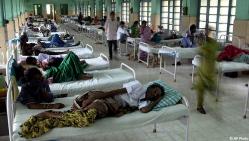 Relatives attend to HIV positive patients in a hospital near Madras, India, Nov. 28, 2003 [AP]