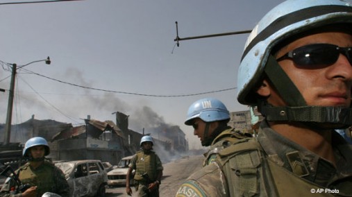 UN peacekeepers stand guard during a fire in Port-au-Prince, Haiti on May 31, 2005. [AP File Photo]