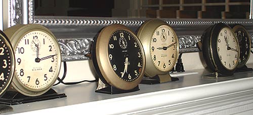 image of several clocks on mantel