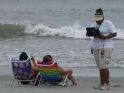 image of author taking a survey on the beach