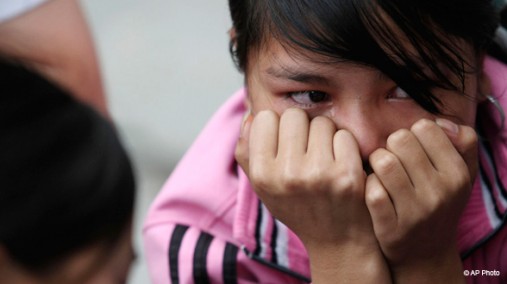 Girl reacts after rescue from factory in Dongguan, China, Apr. 28, 2008. [AP File Photo]