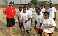 Photo of students at the Karu school beginning a light workout under the supervision of Sports Envoy Marcelo Balboa