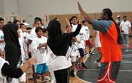 Photo of Andrea giving hearty high-fives to participants