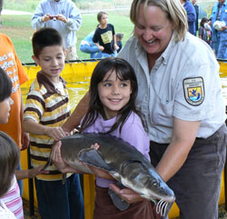 Student holding a sturgeon at the La Crosse National Fish and Wildlife Conservation Office. Credit: USFWS