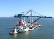 A 16-story crane travels down the Columbia River to the Port of Portland.