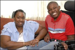 Photo: A mother sitting next to her son in a wheelchair.