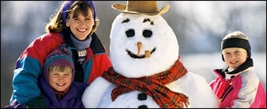 Photo: A mother and children gathered around a snowman