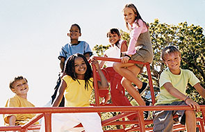 A group of kids climbing on a jungle gym.