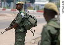 Regular Congolese army soldiers hold a position on a street corner in Kinshasa as the battle between regular army units and soldiers loyal to Jean-Pierre Bemba intensifies