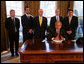 President George W. Bush speaks to the press after the signing of the 2008 Economic Report Monday Feb. 11, 2008, in the Oval Office. Joining President Bush are, from left, Chuck Blahous, Deputy Assistant to the President for Economic Policy; Pierce Scranton, Chief of Staff, Council of Economic Advisors; Eddie Lazear, Chairman, Council of Economic Advisors; Donald Marron, Senior Economic Advisor, Council of Economic Advisors; and Keith Hennessey, Assistant to the President for Economic Policy.  White House photo by Joyce N. Boghosian