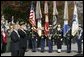 President George W. Bush salutes the playing of the national anthem during a wreath laying ceremony at the Tomb of the Unknowns on Veterans Day Thursday, Nov. 11, 2004. "Today we also recall the men and women who did not live to be called "veterans," many of whom rest in these hills. Our veterans remember the faces and voices of fallen comrades. The families of the lost carry a burden of grief that time will lighten, but never lift," said the President in his remarks. White House photo by Paul Morse