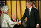 President George W. Bush awards the Presidential Medal of Freedom to Liberian President Ellen Johnson Sirleaf during a ceremony Monday, Nov. 5, 2007, in the East Room. "When free elections returned to Liberia, the voters made history," said President Bush. "They chose her to be the first woman ever elected to lead a nation on the continent of Africa."  White House photo by Eric Draper