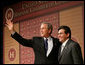 President George W. Bush stands with Attorney General Alberto Gonzales as they acknowledge the applause after the President addressed the Hispanic Chamber of Commerce Legislative Conference Wednesday, April 20, 2005, in Washington, D.C.  White House photo by Eric Draper