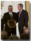 President George W. Bush stands with Thornton Stanley of Stanley Construction, Huntsville, Alabama who holds his award for the Small Business Person of the Year during a ceremony in the East Room, Tuesday, May 8. WHITE HOUSE PHOTO BY ERIC DRAPER